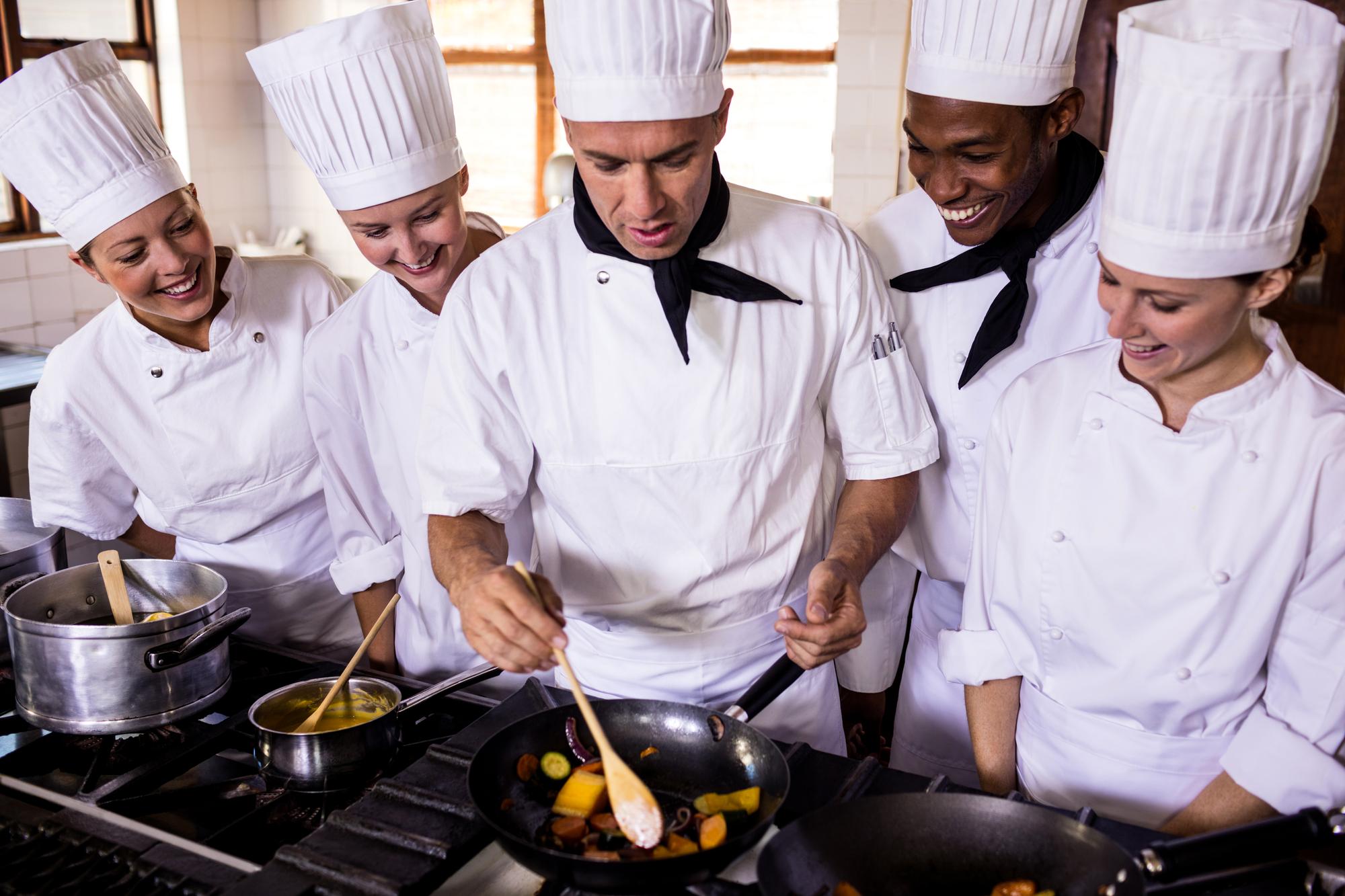 Workshop kitchen with chef demonstrating technique